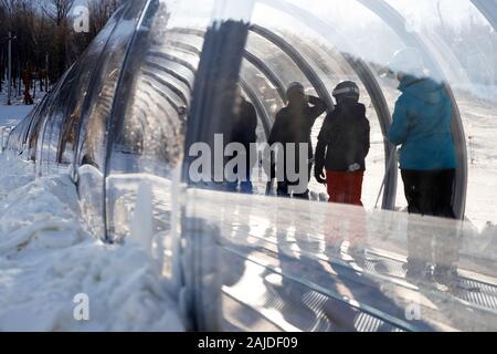 Skiers on a covered magic carpet on the learner's slope aka Bunny slope at Mont-Orford Ski Resort. Mont-Orford National Park.Orford.Quebec.Canada Stock Photo