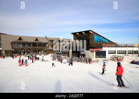 skiers outside of the main building of Mont-Orford ski resort. Mont-Orford National Park. Orford.Quebec.Canada Stock Photo