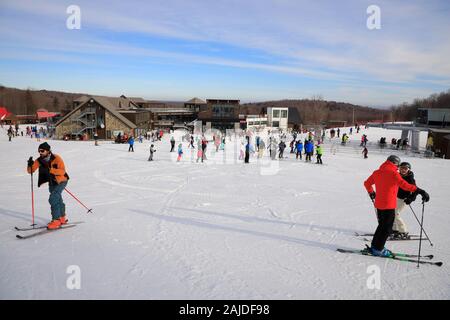 skiers outside of the main building of Mont-Orford ski resort. Mont-Orford National Park. Orford.Quebec.Canada Stock Photo