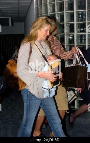 MIAMI,  FL. JANUARY 5 2005: Rocker Rod Stewart and his fiancee, former model Penny Lancaster arrive at Miami International Airport from the UK with their newborn baby, Alastair Wallace Stewart.  January 08, 2006 in Miami, Florida.  People; Rod Stewart; Penny Lancaster; Alastair Wallace Stewart Stock Photo