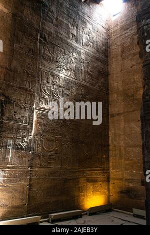 enlightened hieroglyphs Inside the sanctuary at the centre of the egyptian Temple of Horus at Edfu, in Egypt. Stock Photo