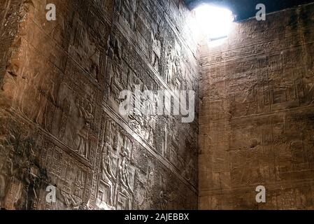 enlightened hieroglyphs Inside the sanctuary at the centre of the egyptian Temple of Horus at Edfu, in Egypt. Stock Photo