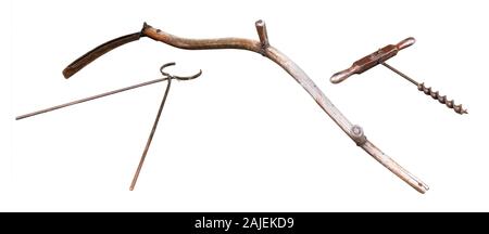 Old-fashioned rusty and well-used tools and farm equipment, isolated on a white background Stock Photo
