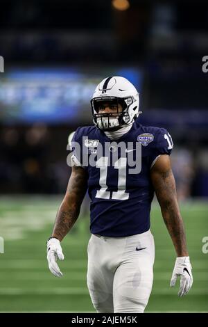 Penn State linebacker Micah Parsons, right, holds a team jersey with NFL  Commissioner Roger Goodell after the was chosen by the Dallas Cowboys with  the 12th pick in the NFL football draft