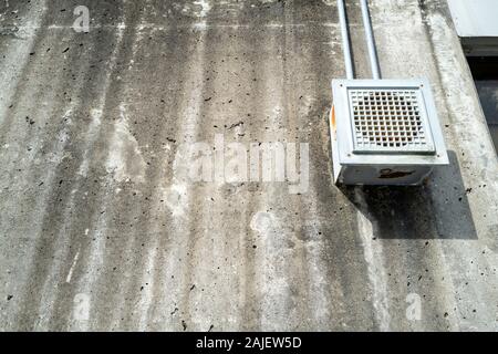 Speaker in Plastic Housing on a Concrete Wall Stock Photo