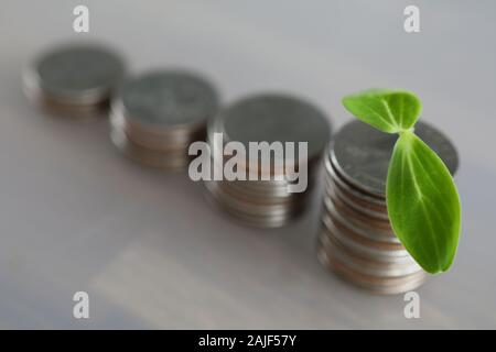 Chart tower with silver metall coin against gray background Stock Photo