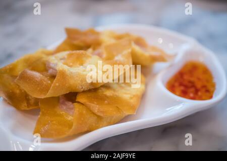 Close-up view of  the deep fried pork dumpling with sauce. Stock Photo