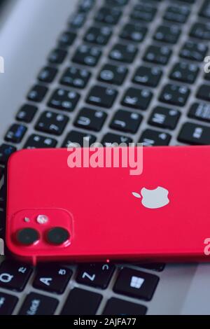 Red color iPhone 11 featuring dual camera released in fall of 2019. iPhone 11 quickly became fastest selling smartphone of 2019 Stock Photo