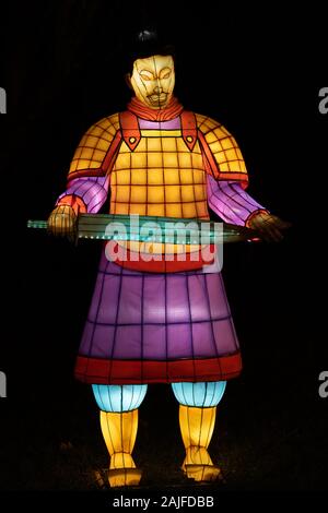 Warsaw, Poland - December 16, 2019: Ancient warrior with a sword at Chinese Light Festival, traditional Chinese culture exhibition at night at Fort Be Stock Photo