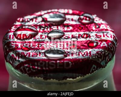 Milk Bottle Top - Semi Skimmed Milk Bottle top wet from rain Stock Photo