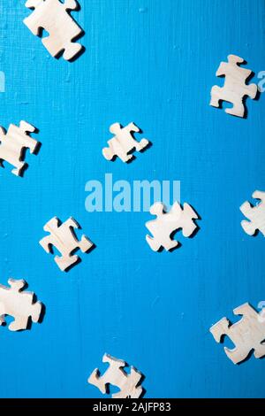 Scattered Jigsaw Pieces on Blue Surface Stock Photo