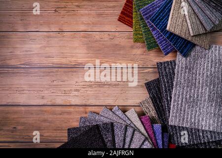 floor carpet samples on brown wooden background with copy space Stock Photo