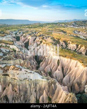 A view of the majestic landscape of Cappadocia near Goreme, Turkey during an early morning hot air balloon flight Stock Photo