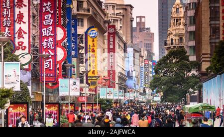 Shanghai, China: Nanjing road crowded with people, shopping street, shop signs and shop signboards. Cityscape photography, urban scene Stock Photo