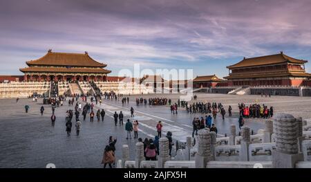Beijing, China: Beautiful scenic panoramic aerial view of Forbidden City with crowd of visitors and tourists sightseeing at sunset in winter Stock Photo