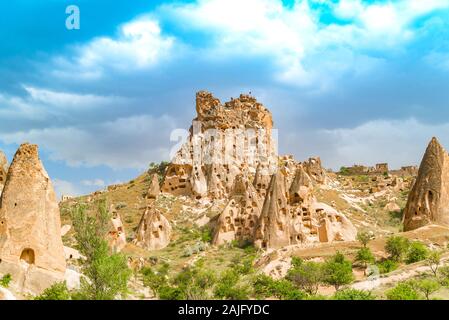 Uchisar Castle in Cappadocia, Turkey surrounded by fairy chimney rock formations Stock Photo