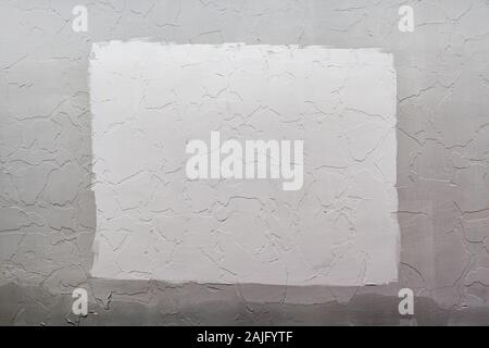 Gray plaster wall background with white rectangle in center, Mockup and backdrop. Stock Photo