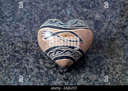 Valentine's heart made of stone photographed on a marble slab Stock Photo