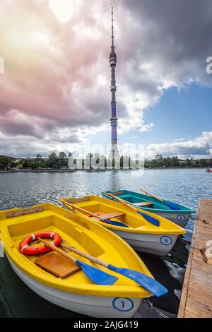 Ostankino television tower with yellow boats at foreground. Broadcasting center at Moscow, Russia. Moscow, Russia - August 06 2019. Stock Photo