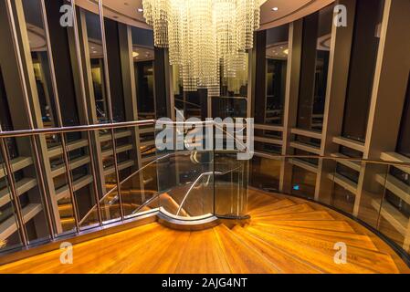 Dubai, United Arab: At the Top, interior of  Burj Khalifa spiral winding staircase stairs (floor 124 125) and crystal chandelier interiors Stock Photo