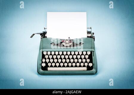 Vintage typewriter with paper sheet. Space for your text. Old photo filter applied. Stock Photo