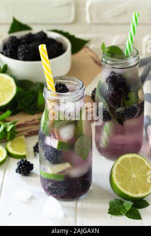 Homemade refreshing citrus lemonade mojito blackberry with  ingredients for making on wooden table. Stock Photo