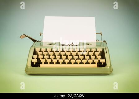 Vintage typewriter with paper sheet. Space for your text. Old photo filter applied. Stock Photo