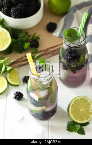 Homemade refreshing citrus lemonade mojito blackberry with  ingredients for making on wooden table. Free space for your text. Stock Photo