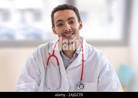 Young male doctor confident african american hispanic Stock Photo
