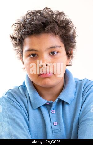 Preteen boy face close up portrait in blue shirt Stock Photo