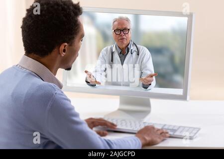 In-home care for a young male patient with telemedicine or telehealth, virtual live chat. Stock Photo