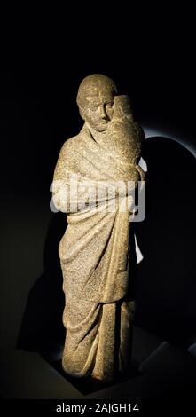 Opening visit of the exhibition “Osiris, Egypt's Sunken Mysteries”. A statue of a man, probably an Osiris priest, carrying a canopic jar. Stock Photo