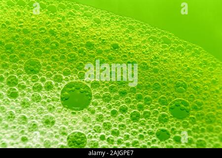 Macro image foam bubbles from soap or shampoo washing against a green background Stock Photo