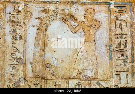 UNESCO World Heritage, Thebes in Egypt, Assassif (part of the Valley of the Nobles), tomb of Pabasa. Man pouring water. Stock Photo