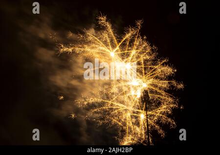multiple burst fireworks display against black sky during holiday celebration Stock Photo