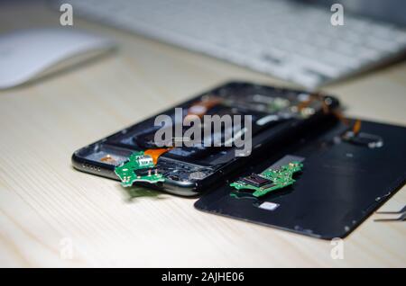 Change the mobile phone electronics circuit board. Smartphone Repair on the table. Stock Photo