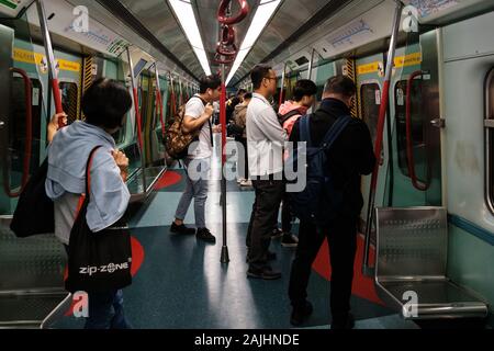 HongKong, China - November, 2019:  People travel inside  metro / MTR  subway train   in Hong Kong Stock Photo