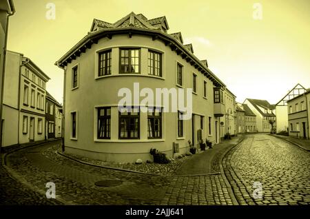 The intersection of the old stone road, modern development in the historic part of the city. Colored black and white photo, retro style old postcard. Stock Photo