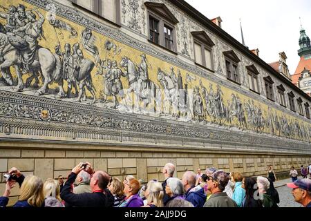 Tourists admire and photograph the 335 foot long outdoor mosaic called the Procession of the Princes and was build in 1872 Stock Photo