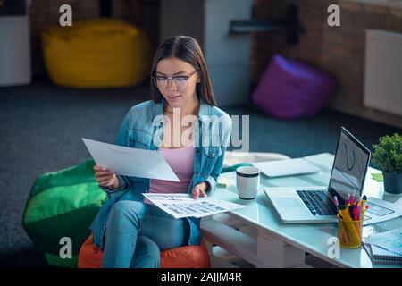 Nice young woman being engaged in work Stock Photo
