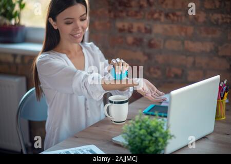 Nice joyful woman doing the arms massage Stock Photo