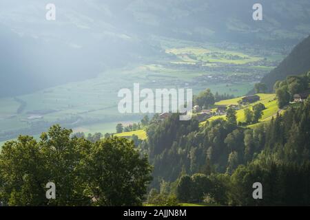 Patches of sunlight in a mountain valley in the early evening Stock Photo