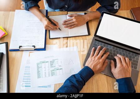 Young students classmates help friend catching up workbook and learning tutoring in a library, education and school concept. Stock Photo