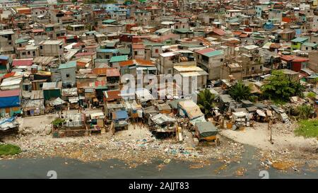 Slums in Manila near the port. River polluted with plastic and garbage. Manila, Philippines. Stock Photo