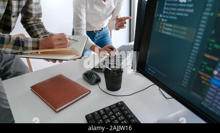 Pensive programmer working on desktop pc programming code technologies or website design at office Software Development Company Stock Photo