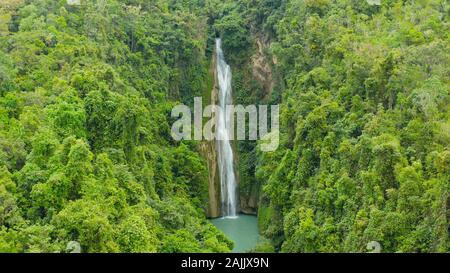 Aerial view of Mantayupan waterfalls in a mountain gorge in the tropical jungle, Philippines, Cebu. Waterfall in the tropical forest. Stock Photo