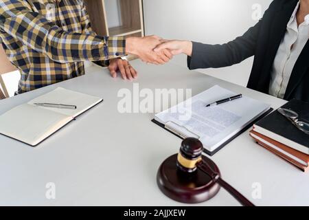 lawyer or attorneys shaking hand with client after consultation discussing a contract agreement customer at courtroom, judge service concept Stock Photo
