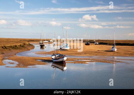 Boats on the sand flats of the East Fleet at low tide, Wells-next-the-Sea, Norfolk, England, United Kingdom, Europe Stock Photo