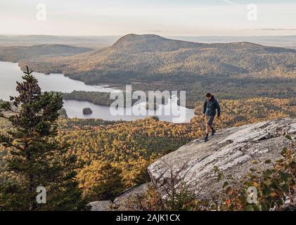 male hiker walks along cliff with view on Appalachian Trail, Maine Stock Photo