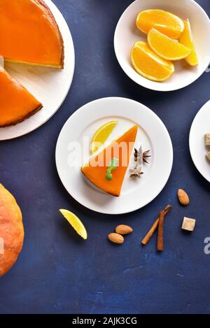 Pumpkin orange pie on blue stone background. Healthy or vegetarian dessert concept. Top view, flat lay Stock Photo